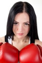 Portrait of a beautiful brunette girl in red boxing gloves. Royalty Free Stock Photo