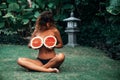 Portrait beautiful brunette girl in swimsuit with watermelon fruit holding in hands. model with perfect body, cute Royalty Free Stock Photo