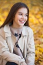 Portrait of a beautiful brunette little girl, autumn park outdoors Royalty Free Stock Photo