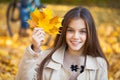 Portrait of a beautiful brunette little girl, autumn park outdoors Royalty Free Stock Photo