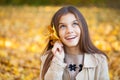 Portrait of a beautiful brunette little girl, autumn park outdoors Royalty Free Stock Photo