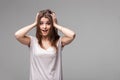 Portrait of beautiful brunette woman with a astonished expression posing in studio on gray background Royalty Free Stock Photo