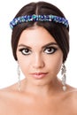 Portrait of beautiful brunette woman with big earring and shinny accessories in hair. Perfect arabic makeup with long