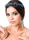 Portrait of beautiful brunette woman with big earring and shinny accessories in hair. Perfect arabic makeup with long