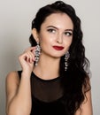 Portrait of beautiful brunette woman in black dress. Fashionable woman with perfect lips Royalty Free Stock Photo