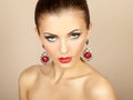 Portrait of beautiful brunette woman with earring. Perfect makeup