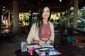 Portrait beautiful brunette woman smiling at wooden table in summer cafe Royalty Free Stock Photo