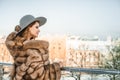 Portrait of beautiful brunette woman wearing fur winter coat and grey hat Royalty Free Stock Photo