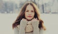 Portrait beautiful brunette young woman wearing a scarf in winter over a snowflakes background Royalty Free Stock Photo