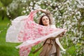 Portrait of a beautiful brunette young women  in blossom apple tree garden in spring time. Enjoy Nature. Healthy girl outdoor. Royalty Free Stock Photo