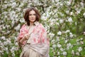 Portrait of a beautiful  brunette young women  in blossom apple tree garden in spring time. Enjoy Nature. Healthy girl outdoor. Royalty Free Stock Photo