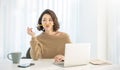 Portrait of beautiful business asian woman thinking with pencil winter sweater in home office desk using computer. Royalty Free Stock Photo