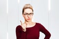 Portrait of beautiful business woman in glasses showing finger up Royalty Free Stock Photo