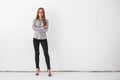 Portrait of beautiful business woman standing against white wall