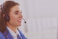 Portrait of beautiful business woman working at her desk with headset and laptop Royalty Free Stock Photo