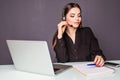 Portrait of beautiful business woman working at her desk with headset and laptop in office Royalty Free Stock Photo