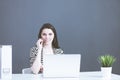 Portrait of beautiful business woman working at her desk with headset and laptop Royalty Free Stock Photo