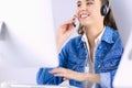 Portrait of beautiful business woman working at her desk with headset and laptop Royalty Free Stock Photo