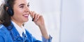 Portrait of beautiful business woman working at her desk with headset and laptop Royalty Free Stock Photo