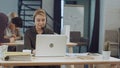 Portrait of beautiful business woman working at her desk with headset and laptop Royalty Free Stock Photo