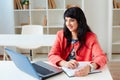 Portrait of beautiful business woman working at her desk with laptop. Royalty Free Stock Photo