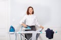 Woman ironing dress shirt before leaving for work