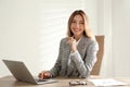 Portrait of beautiful young businesswoman with laptop at table in office Royalty Free Stock Photo