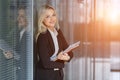 Portrait of beautiful businesswoman smiling and standing with folder in the office Royalty Free Stock Photo