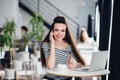 Portrait of beautiful businesswoman talking on the phone while enjoying hot coffee in the cafe. Adult attractive female Royalty Free Stock Photo