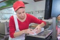 Portrait beautiful butcher packing meat in paper at shop