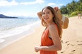 Portrait of beautiful carefree girl holding straw hat on tropical beach looking away Royalty Free Stock Photo