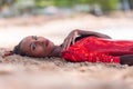 Portrait of Beautiful Caribbean Adult Teen in Barbados. Wearing Red Bikini and Lying on a tropical beach. Caribbean Sea in Royalty Free Stock Photo