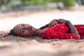 Portrait of Beautiful Caribbean Adult Teen in Barbados. Wearing Red Bikini and Lying on a tropical beach. Caribbean Sea in Royalty Free Stock Photo