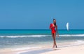 Portrait of Beautiful Caribbean Adult Teen in Barbados. Wearing Red Bikini and Walking on a tropical beach. Caribbean Sea in Royalty Free Stock Photo