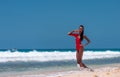 Portrait of Beautiful Caribbean Adult Teen in Barbados. Wearing Red Bikini and Walking on a tropical beach. Caribbean Sea in Royalty Free Stock Photo