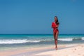 Portrait of Beautiful Caribbean Adult Teen in Barbados. Wearing Red Bikini and Walking on a tropical beach. Caribbean Sea in Royalty Free Stock Photo