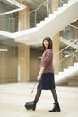 Mature woman walking confidently in mall while looking at camera Royalty Free Stock Photo