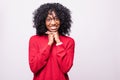 Portrait of beautiful casually dressed african young woman in round glasses having doubtful expression, looking away in Royalty Free Stock Photo