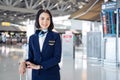 Portrait of beautiful Caucasian flight attendant staff smiling and looking at camera with confidence face and happiness in airport