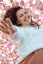 portrait of beautiful caucasian woman with blooming sakura cherry trees Royalty Free Stock Photo