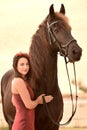 Lady in red with her black horse Royalty Free Stock Photo