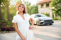 Portrait of a beautiful, charming, classy woman in a white with a fun personality in a summer dress at expensive luxury estate, tr Royalty Free Stock Photo