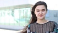 Portrait of a beautiful charming smiling happy girl with beautiful smile, wind blows the hair.