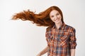 Portrait of beautiful cheerful redhead girl with flying curly hair smiling laughing looking at camera over white Royalty Free Stock Photo