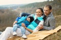 Active young happy family on picnic. Portrait of a beautiful cheerful young family