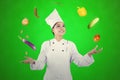 Beautiful chef juggling food ingredients on studio Royalty Free Stock Photo