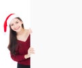 Portrait of beautiful christmas asian young woman in santa hat holding board