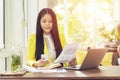 Portrait of beautiful and confident Asian business woman in working with notebook laptop and book manage job work at workplace. Royalty Free Stock Photo