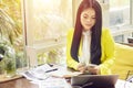 Portrait of beautiful and confident Asian business woman in working with notebook laptop and book manage job work at workplace. Royalty Free Stock Photo