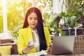 Portrait of beautiful and confident Asian business woman in working with notebook laptop and phone manage job work at workplace. Royalty Free Stock Photo